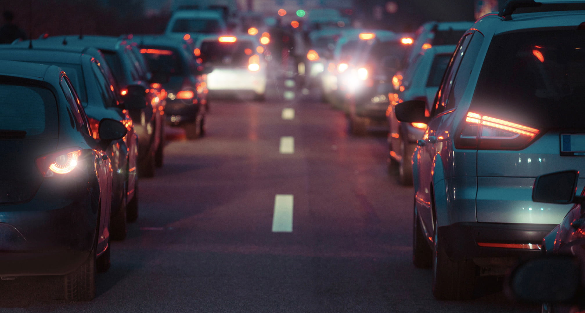 Halos of light around car tail lights at night caused by astigmatism (left). Clear car tail lights at night seen by normal eye (right)